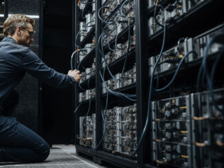 Engineer adjusting Bitcoin mining servers in a data center amid network power struggle over anti-spam proposal and disputed node support